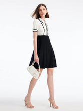 a woman in black and white short dress